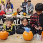 working hard decorating pumpkins